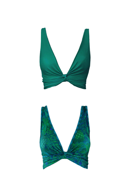 A product image displaying the high cut Brasilia bikini top in each of it's reversible sides. One is solid emerald green and the other features a motif print in shades of cool green and teal.