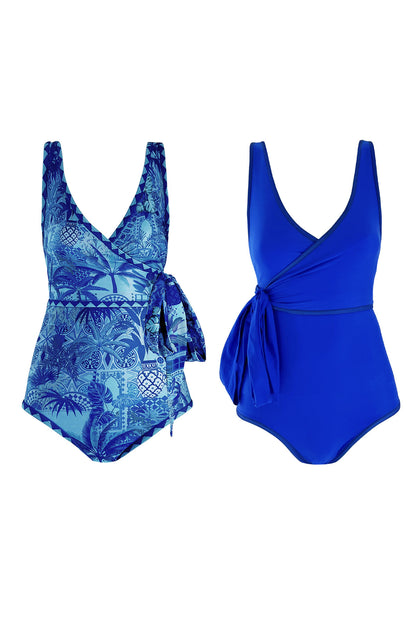 Flat lay product image displaying a wrapsuit in both the solid ultramarine coloured blue side and reversible Italian motifs inspired print side.